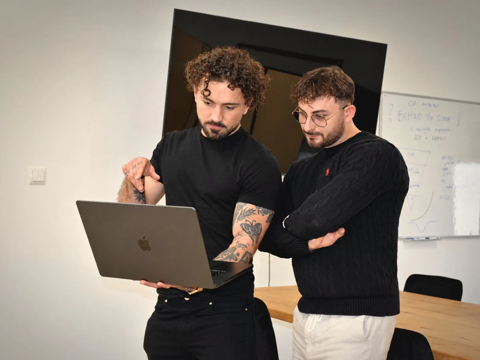 Discussing a business order at a laptop
